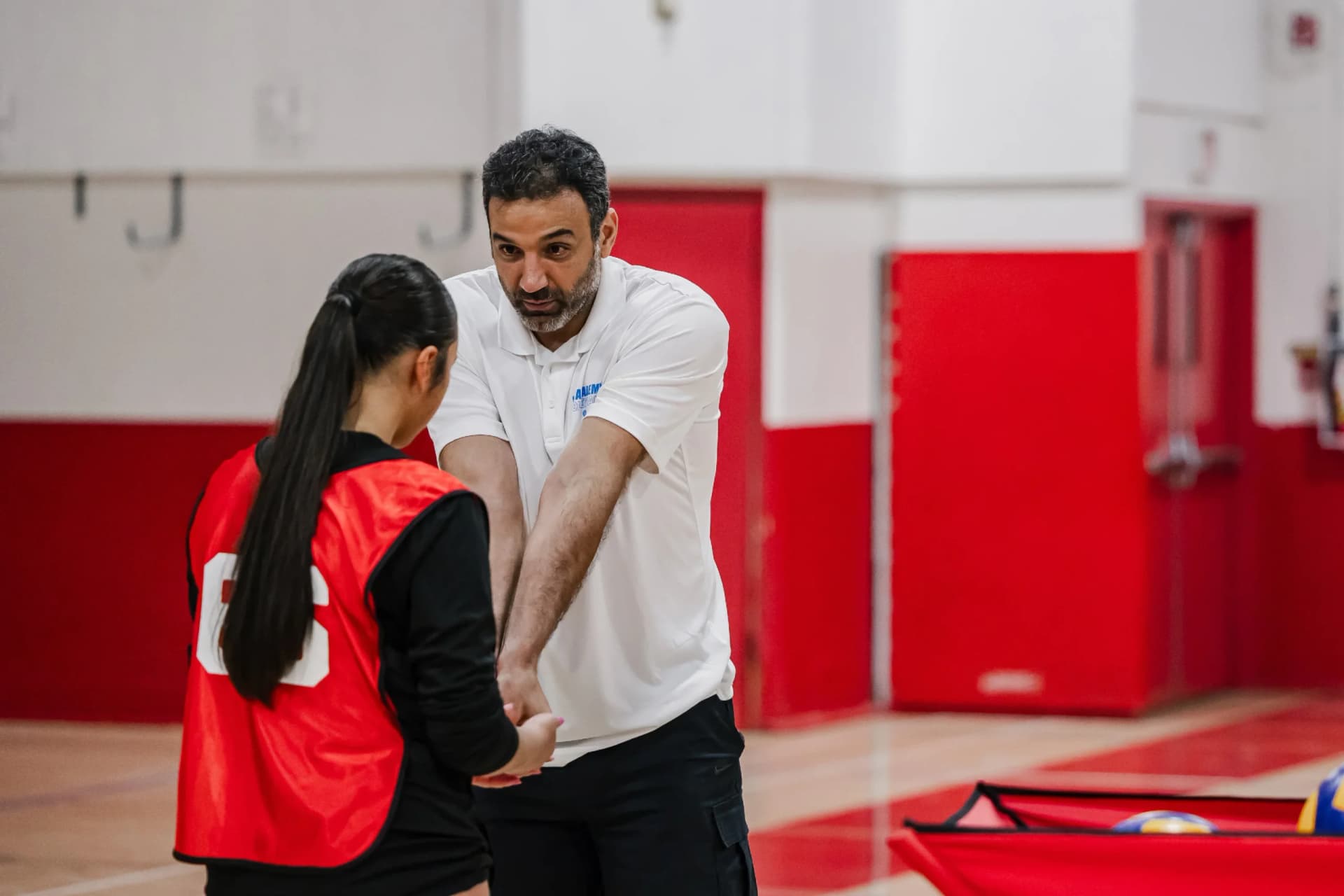 Coach providing feedback during holiday camp