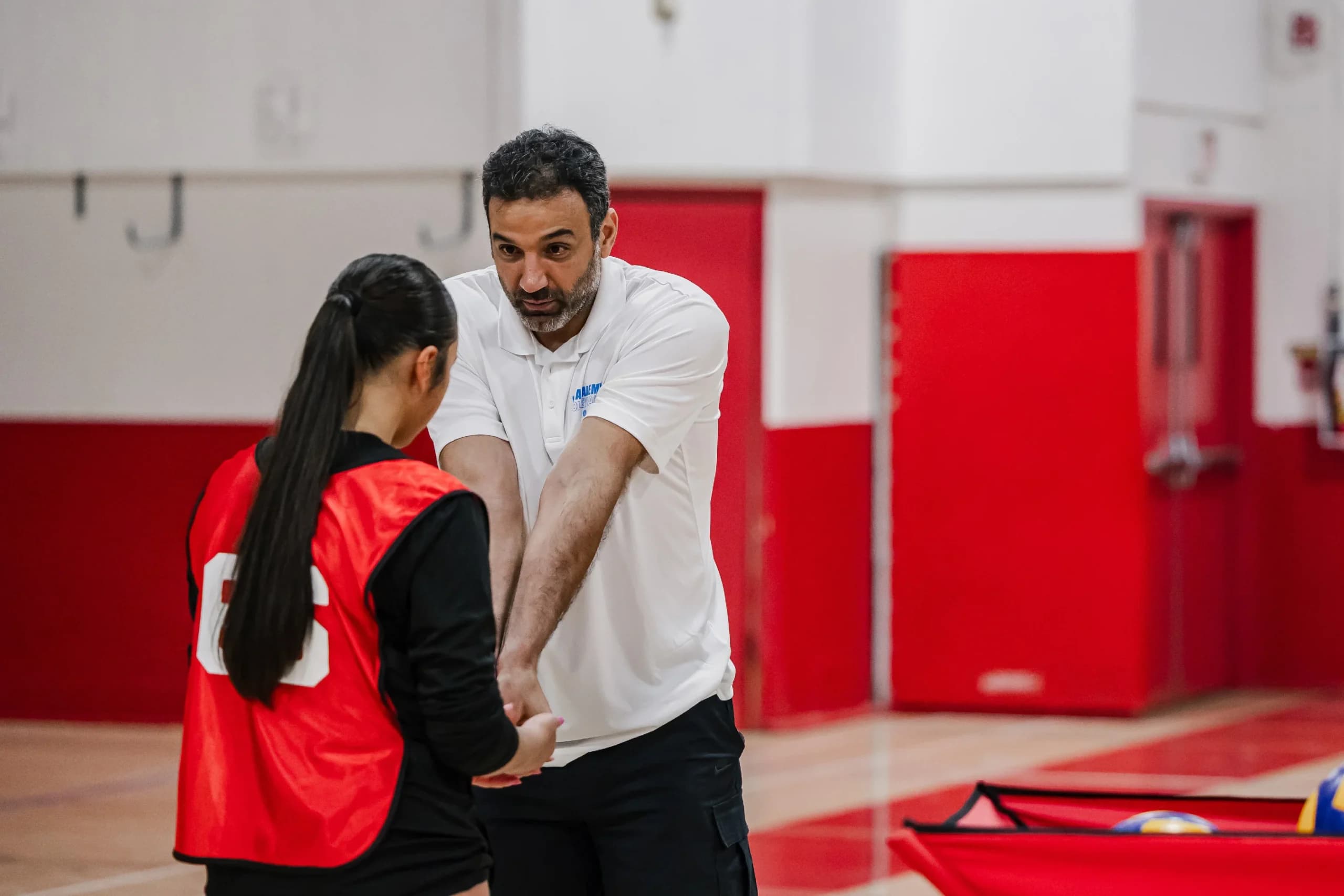 TXVA coach providing one-on-one youth volleyball training feedback